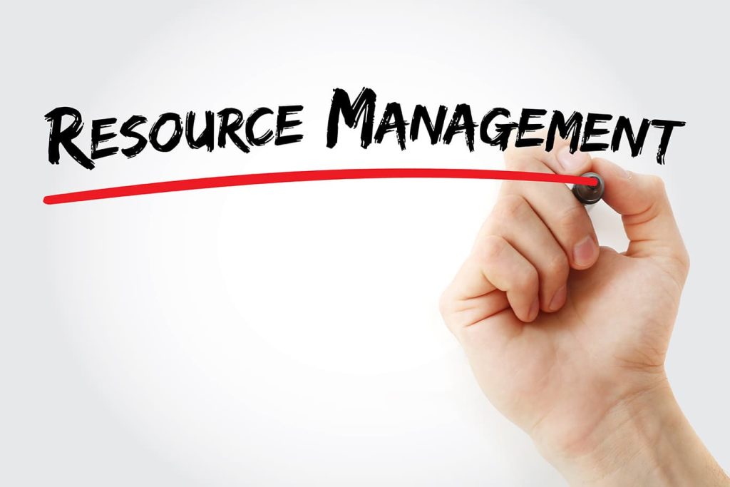 Hand holding a card labeled Resource Management for strategic project planning