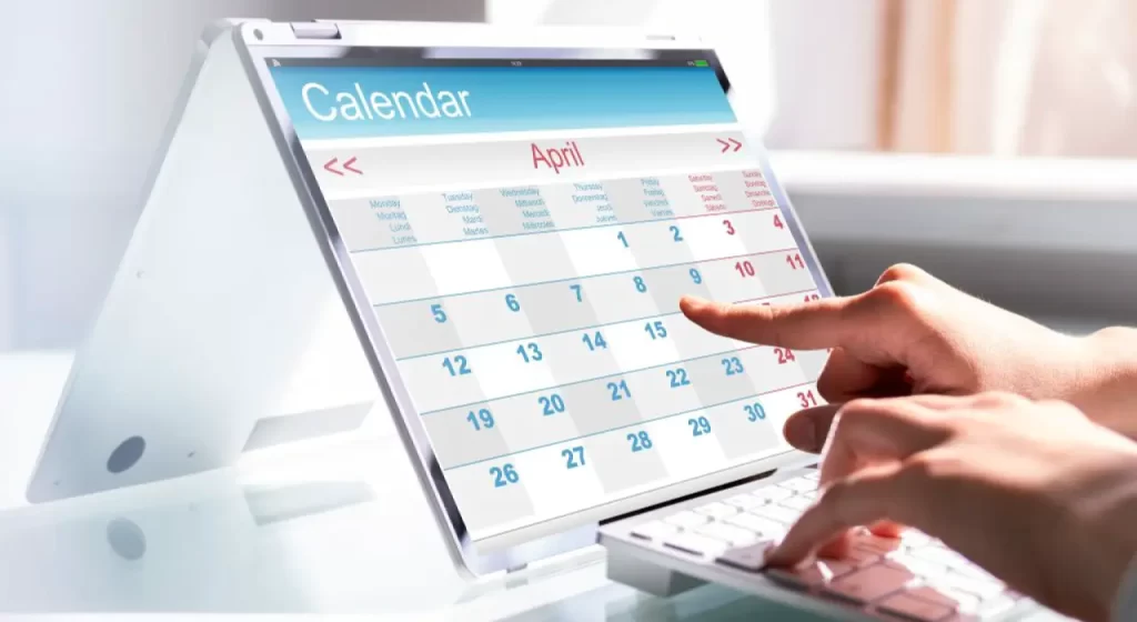Person selecting a date on a tablet-based employee scheduling calendar